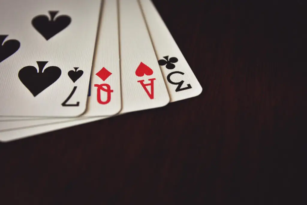 Poker cards showing a straight with two aces