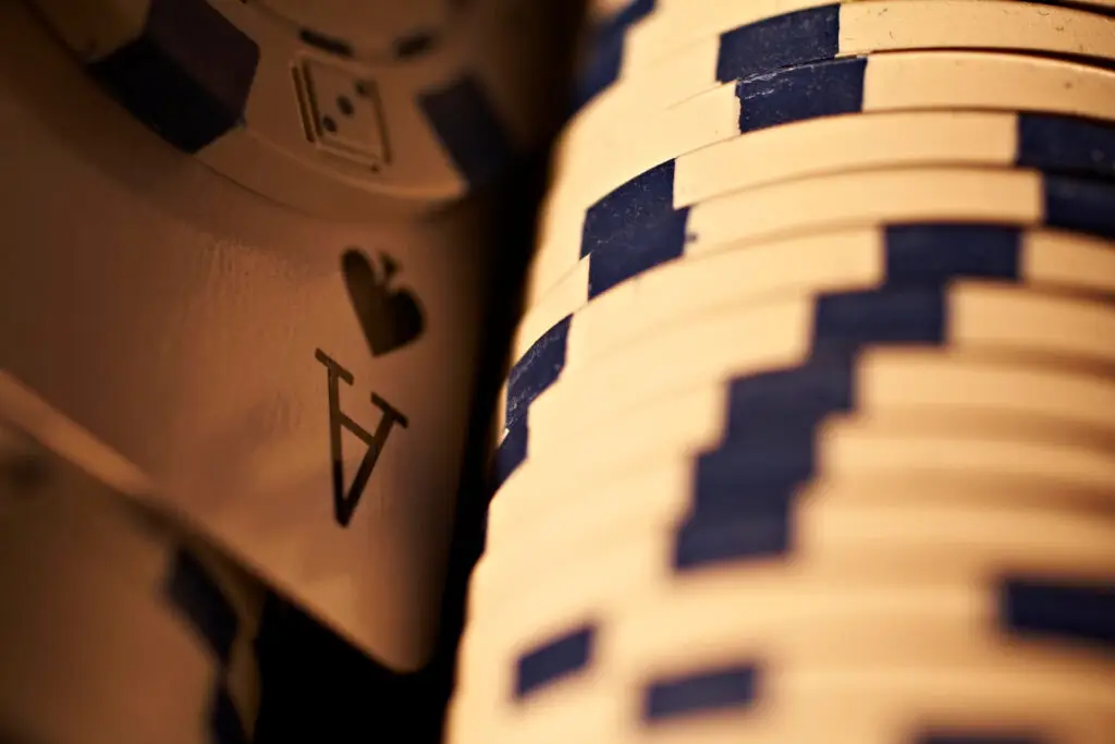Big chip bet next to a turned-up ace of spades